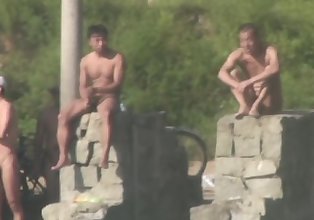 Chinese Men swimming at lake