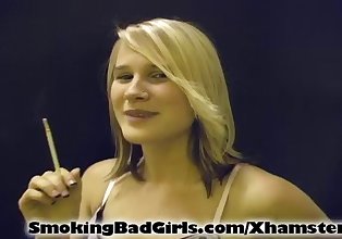 Blonde teen smokes cigarette in black lingerie