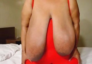 Gloria Stutters plays with her huge tits.