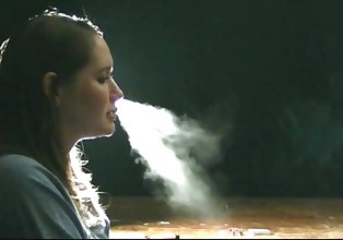 Heather smokes a cigar