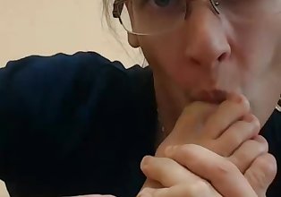 Nerdy babe in glasses sucks her feet and toes on webcam