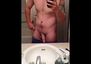 Stroking cock in the mirror