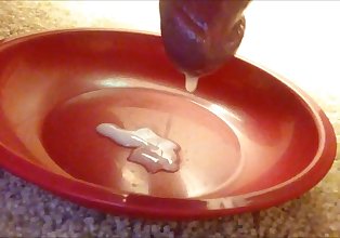 Slow-motion cumshot onto a plate