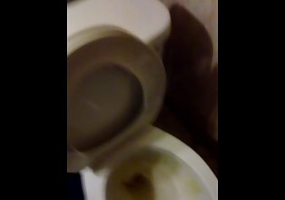 Pissing in toilet and on wall.
